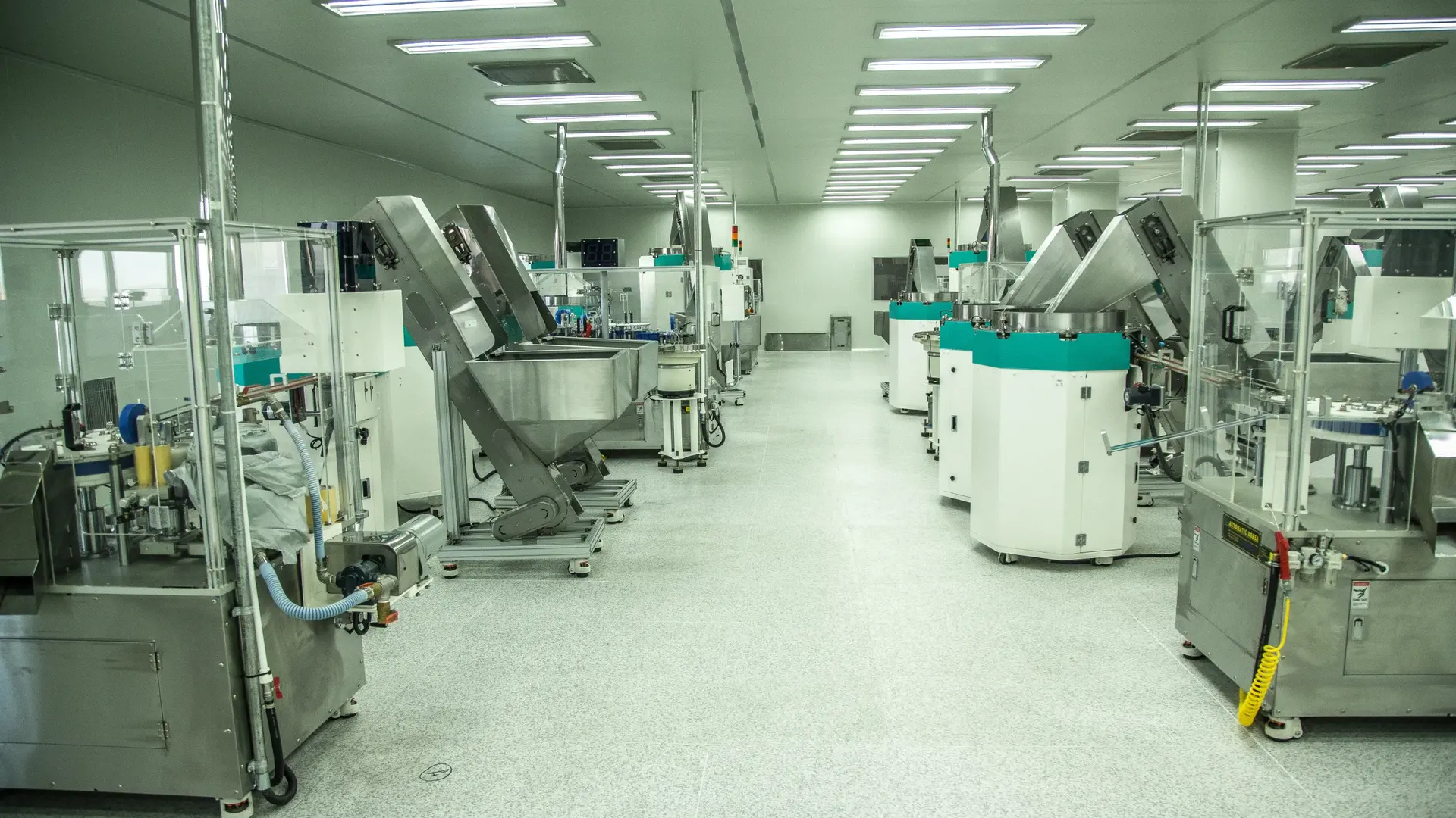 Cleanroom production line with hoppers, filling machines and stainless steel equipment