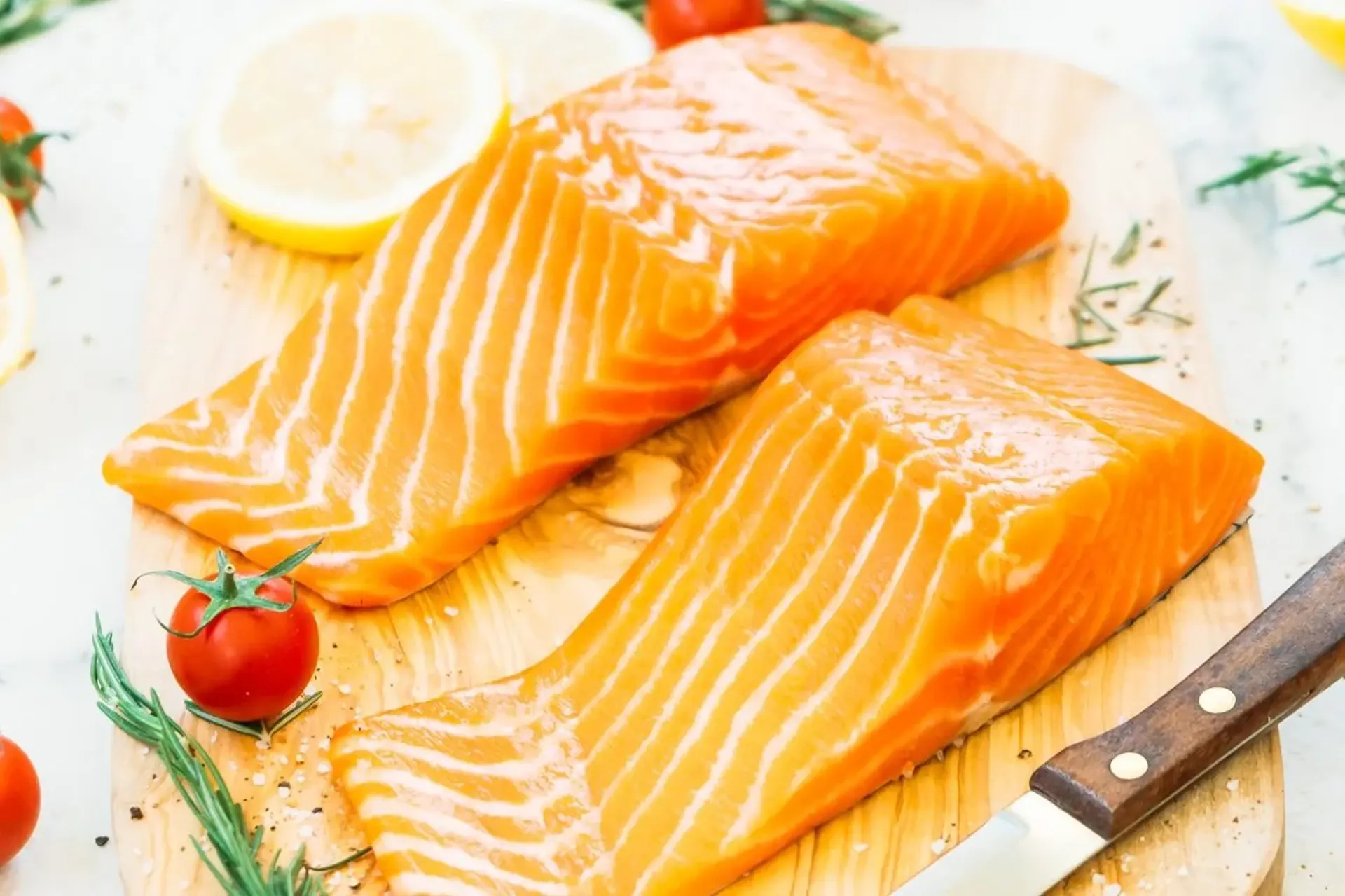 Raw salmon fillet on a wooden cutting board